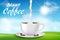Cup of cappuccino coffee composition with sunny morning and green grass design. Black coffee cup with milk splash and