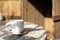 cup with cappuccino coffee on a vintage table with a background of old rustic woods