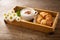 Cup of cappuccino , croissants and daisy flowers on a wooden tray