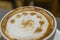 The cup of cappuccino with a decorative pattern