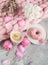 Cup with cappuccino, doughnut, pink pastel giant blanket, flowers