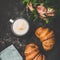 Cup of cappuccino, fresh croissants and flowers, square crop