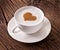 Cup of cappuccino with ground cinnamon in the form of heart.