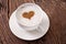 Cup of cappuccino with ground cinnamon in the form of heart.