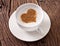 Cup of cappuccino with ground cinnamon in the form of heart.