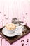 Cup of cappuccino with heart foam, set of cup of coffee with coffee beans on pink wooden background, drink hot product photography