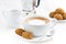 Cup of cappuccino and macaroons on white table, selective focus
