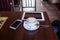 Cup of Cappuccino and mobile phone and tablet pc on wooden table