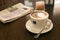 Cup of cappuccino and newspaper