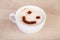 Cup of cappuccino with smiley