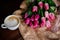 Cup of cappuccino and tulips.