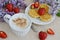 Cup of cappuccino with waffles, strawberries and flowers