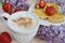 Cup of cappuccino with waffles, strawberries and flowers