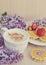 Cup of cappuccino with waffles, strawberries and flowers