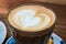 Cup of cappucino and biscuits on a wood background