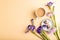 Cup of cioffee with chocolate candies and lilac iris flowers on orange pastel background. top view, copy space