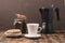 Cup of cofee with cofee beans and black maker. Selective focus. Cup of black coffee in a cup, donut with nuts and grains in a