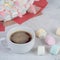 A cup of coffee on the background of sweets Marshmallows, close-up.Holiday concept, congratulations