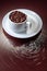 Cup with coffee beans on a brown background