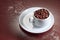 Cup with coffee beans on a brown background