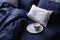 Cup of coffee on bed with stylish silky linens