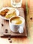 Cup of Coffee with a Biscotti. Symbolic image. Rustic wooden background.