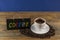 A cup of coffee and blackboard with inscription