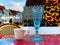 Cup of coffee , blue glass of wine on red table top ,Christmas  tree snowy holiday in Tallinn old town hall square  , winter stree