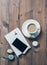 Cup of coffee and blue macaroons on wooden table background