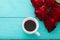 Cup of coffee on blue wooden table. Top view. Mock up. Hot drink. Selective focus. Red rouses bouquet. Valentine mother day
