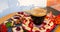 A cup of coffee, bread with confiture, almonds, banana, berries