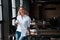 With cup of coffee. Businesswoman with curly blonde hair indoors in cafe at daytime