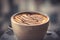 Cup of coffee cappuccino with syrup on blurred background in warm colors