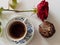 Cup of coffee, chocholate muffin and red rose, from above