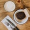 Cup of coffee and chocolate cake on wooden table. Vintage fork and knife. Squred photo Vintage dish