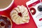 A cup of coffee with a Chocolate Dip Donut and Honey Cruller Donut with an iPhone Plus and the Tim Hortons app