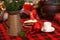 Cup of coffee and christmas toy on wooden table. A copper jug â€‹â€‹and fir branches stand on table.