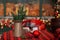 Cup of coffee and christmas toy on wooden table. A copper jug â€‹â€‹and fir branches stand on table.