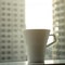 Cup of coffee with city scape background