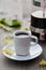 Cup of coffee, coffee pot and linden flower on the table