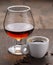 Cup of coffee, cognac glass and coffee beans