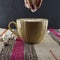 A Cup of coffee in a cozy style on a striped fabric background with marshmallows