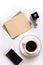 Cup of coffee with diary, smartphone  and perfume around white background. life style flat lay