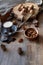 cup coffee  different kinds of nuts  walnut  hazelnuts  almonds on old wooden table boards  edible seed kernels  food concept