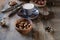 Cup of coffee, different kinds of nuts, walnut, hazelnuts, almonds on old wooden table boards, edible seed kernels, food concept,