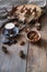 Cup of coffee, different kinds of nuts, walnut, hazelnuts, almonds on old wooden table boards, edible seed kernels, food concept,