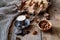 Cup of coffee, different kinds of nuts, walnut, hazelnuts, almonds on old wooden table boards, edible seed kernels, food concept,