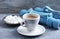 Cup of coffee, dumbbells and Beta-alanine capsules on blue wooden background.