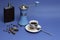 Cup of coffee, flask with cognac and manual coffee grinder on a blue background