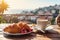 cup of coffee and french croissant on table, balcony with view of beautiful landscape, still life, sea and mountains, resort town